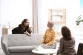 Psychotherapist working with teenage girl and her mother in office Royalty Free Stock Photo