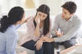 Psychotherapist and young man supporting upset woman during therapy Royalty Free Stock Photo