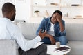 Psychotherapy Concept. Depressed black man talking to psychologist during individual therapy