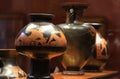 Antique ceramic red-figure psykter and other ancient Greek vases in a museum display case