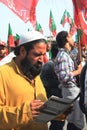 PTI Supporter reads Party Literature outside Rally