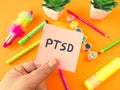 PTSD acronym Post Traumatic Stress Disorder handwritten on sticky note with child supplies. Mental health disorder concept Royalty Free Stock Photo