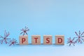 PTSD letters in wooden blocks on blue background. Coping with anxiety, stress, ptsd and depression during covid-19 pandemic Royalty Free Stock Photo