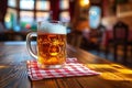 Pub interior, a mug of beer on top of a wooden table covered with red and white checkered tablecloth Royalty Free Stock Photo