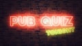 Pub Quiz neon sign mounted on brick wall