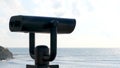 Public beach binoculars, operated with coins with the ocean in the background. Concept. Touristic binoculars, optical