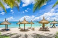 Public beach with lounge chairs and umbrellas, Mauritius island, Africa