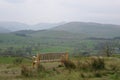 Public bench in front of a Lake distric landscape