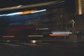 Public bus driving along a night street in the in the city. Motion blur abstract background and texture Royalty Free Stock Photo