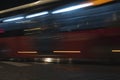 Public bus driving along a night street in the in the city. Motion blur abstract background and texture Royalty Free Stock Photo