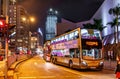 Public bus services in Hong Kong are popular with tourists. Night cityscape with city buses by HK Cultural Centre and Star Ferry Royalty Free Stock Photo
