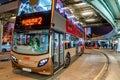 Public bus services in Hong Kong are popular with tourists. Night cityscape with city buses by HK Cultural Centre and Star Ferry Royalty Free Stock Photo