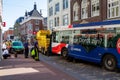 Public bus stuck on retractable bollards with tow truck