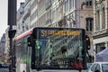 A public bus travels in the old city of Lyon - France - against the backdrop of the magnificent buildings Royalty Free Stock Photo