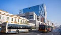 Public buses and modern buildings in city.