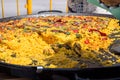 Public celebration or fest in Spain. Large fla frying pan with cooked paella. Selling to guests. Royalty Free Stock Photo
