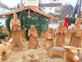 Public christmas creche wooden with carved wood figures outdoors at central plaza