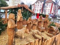 Public christmas crib wooden with big carved wood figures outdoors at central plaza