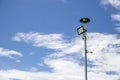 Public city light with solar panel powered on blue sky with clouds Royalty Free Stock Photo
