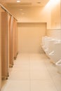 Public clean modern white male toilet, restroom with urinals, in Royalty Free Stock Photo