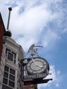 Public clock and figure on the historic 19th century time ball building in briggate leeds city centre. text under the clock reads
