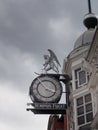 Public clock and figure on the historic 19th century time ball building in briggate leeds city centre. text under the clock reads