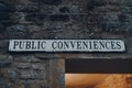 Public conveniences toilet signs on a building in Stow on the Wold, Cotswolds, UK Royalty Free Stock Photo