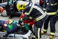 Firefighters prepare patient on litter after car remotion Royalty Free Stock Photo