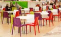 Public dining area with colourul plastic chairs and tables Royalty Free Stock Photo