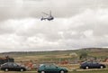 Public emergency service helicopter in the air transporting a seriously injured person from a traffic accident.