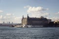 Public ferry boat passes by historical, old train statio Royalty Free Stock Photo