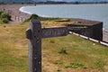 A public footpath sign stands in front of a sunny bay at Blue Anchor in Somerset. Looking west towards Minehead and Porlock Royalty Free Stock Photo