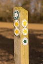 Public footpath signs and labels on a wooden post in the countryside. UK Royalty Free Stock Photo
