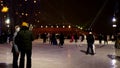 Public ice rink with many people and bumble bee skating outdoor, winter sport activity