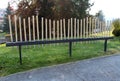 Public installation of musical pipes in various sizes that can be played to simple melody surrounded with paved path and uncut
