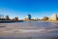 Public library standing near frozen river on bright day