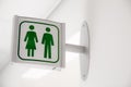 Public modern white and green restroom sign on white wall Royalty Free Stock Photo