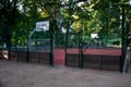 Public multifunctional city playground with tartan surface in the park is used to play basketball football floorball goals baskets