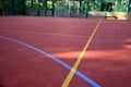Public multifunctional city playground with tartan surface in the park is used to play basketball football floorball goals baskets