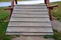 Public multifunctional playground with a sandy impact zone and a stainless steel slide in the park with a sandpit, a and a rope la Royalty Free Stock Photo