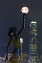 Public outdoor figure with light globe with background of Hong kong island city nightscape