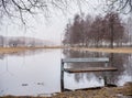 Public Park and Bench on the Water. Early Spring Time. Lithuania, Siauliai. Royalty Free Stock Photo