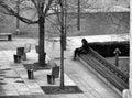 Public park in the spring with a long wooden bench Royalty Free Stock Photo