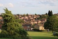 Public park with trees houses and city skyline in background UK