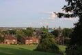 Public park with trees houses and city skyline in background UK