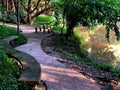 Public park with walkway and trees close to a lagoon