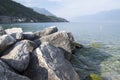 Public pebble beach on the shore of the lake Lago Di Garda, Toscolano Maderno, Italy