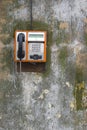 Public phone on grunge wall Royalty Free Stock Photo