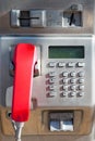 Public phone with a red handset Royalty Free Stock Photo