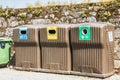 Public recycling bins in front of a stone wall in vila cha, portugal